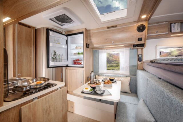 Tischer Wohnkabine Trail 230S mit offener Küche, Kühlschrank und Sitzgruppe – moderner, heller Innenraum.